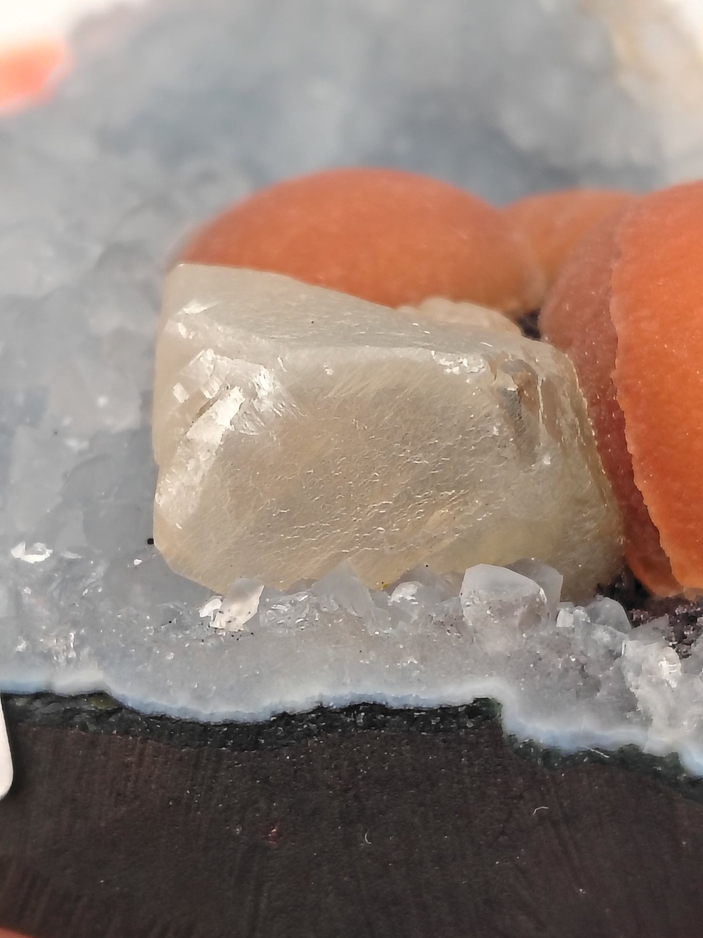Red Fluorite Spheres and Calcite on Quartz